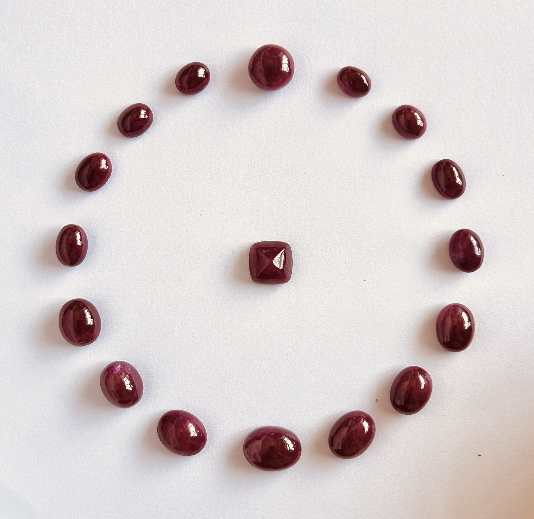 Natural ruby oval cabochon loose gemstones arranged in circular layout
