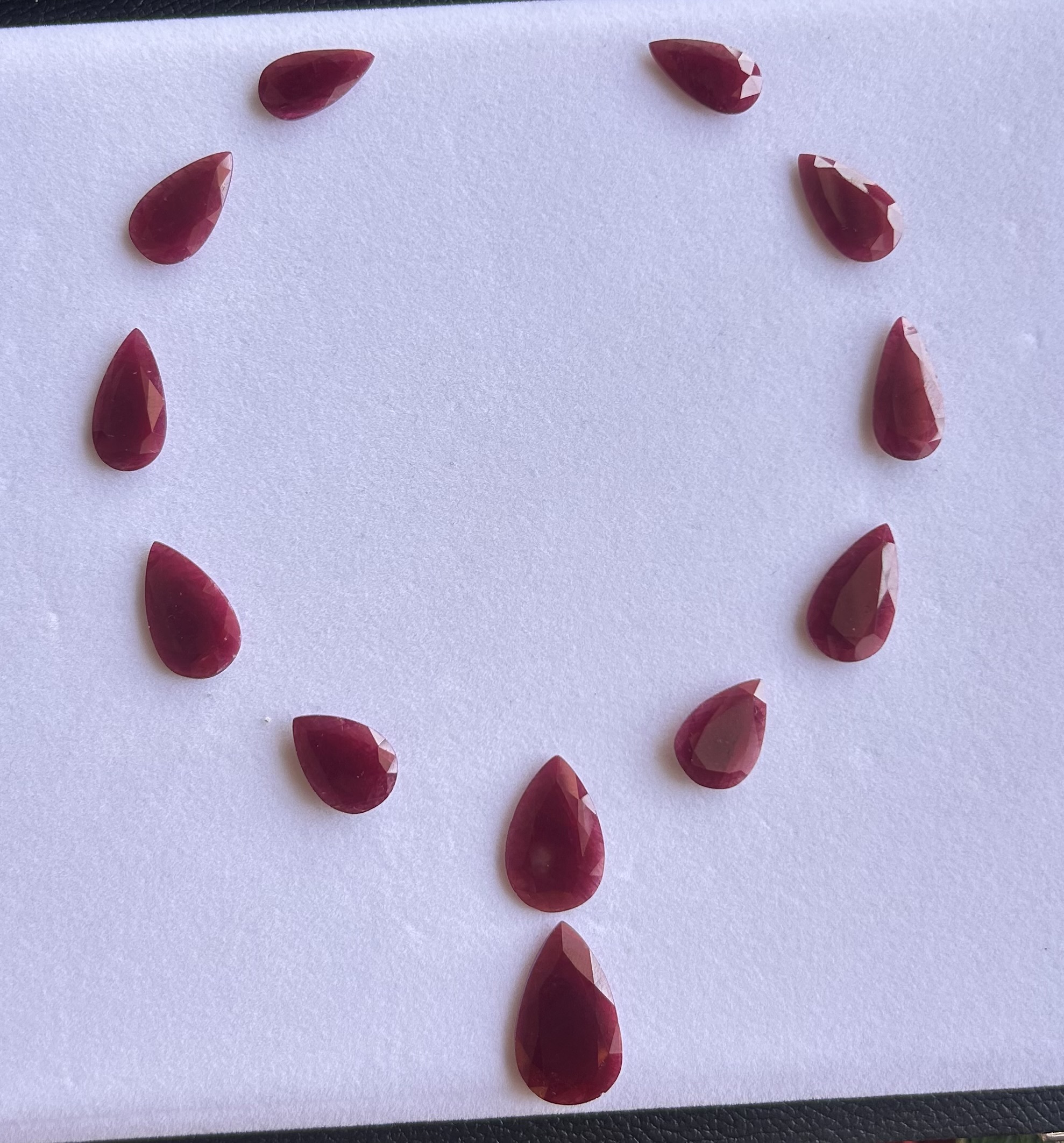 Natural ruby pear cut loose gemstones arranged in circular layout