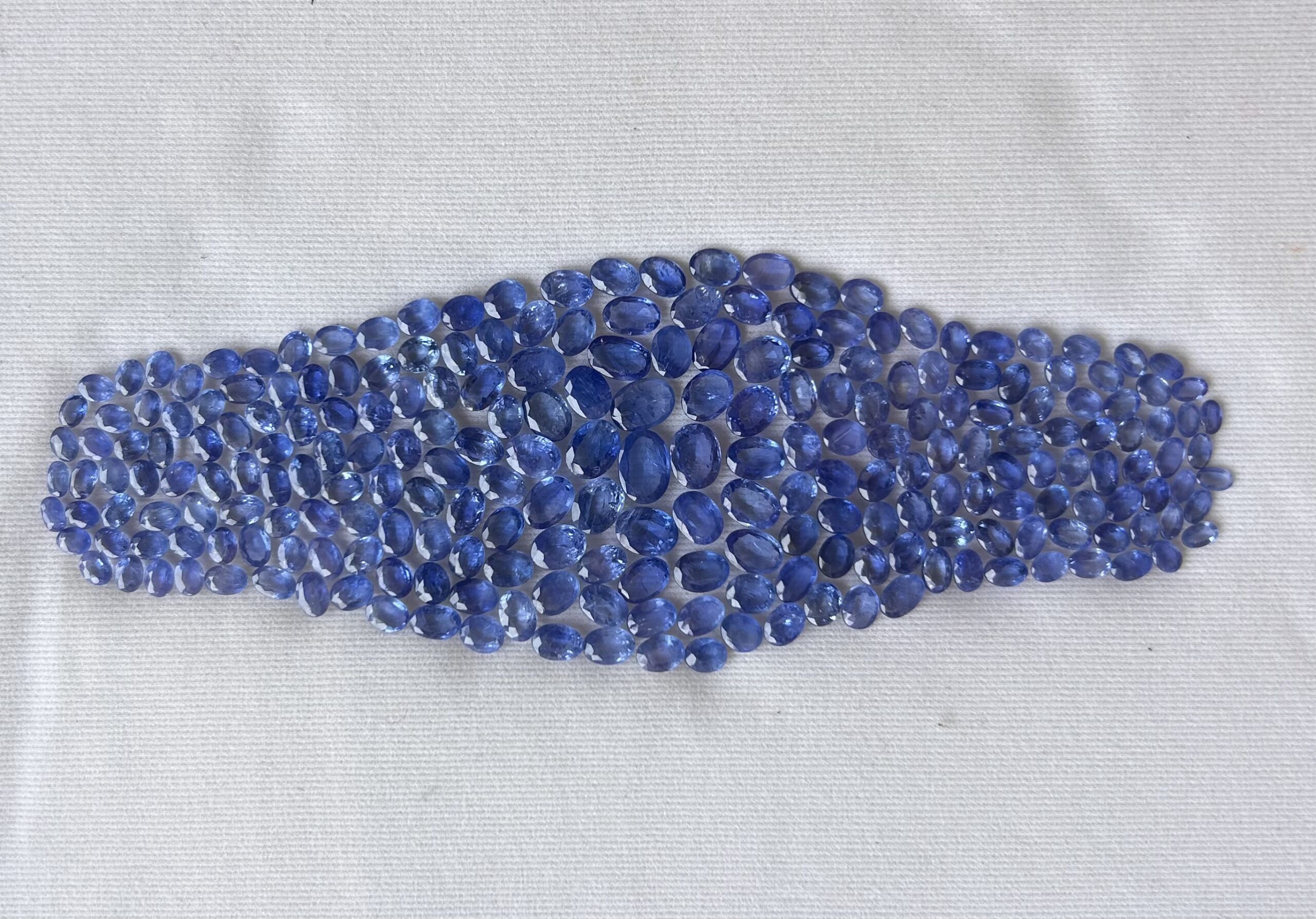 Natural Burmese blue sapphire oval loose gemstones arranged in a layout