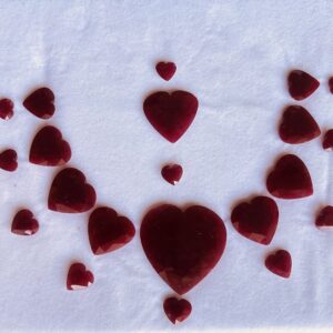 Natural ruby heart cut loose gemstones arranged in decorative layout