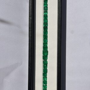 Natural emerald octagon cut loose gemstones arranged in a straight line